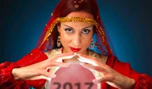 Fortune teller with crystal ball containing the numbers "2017"