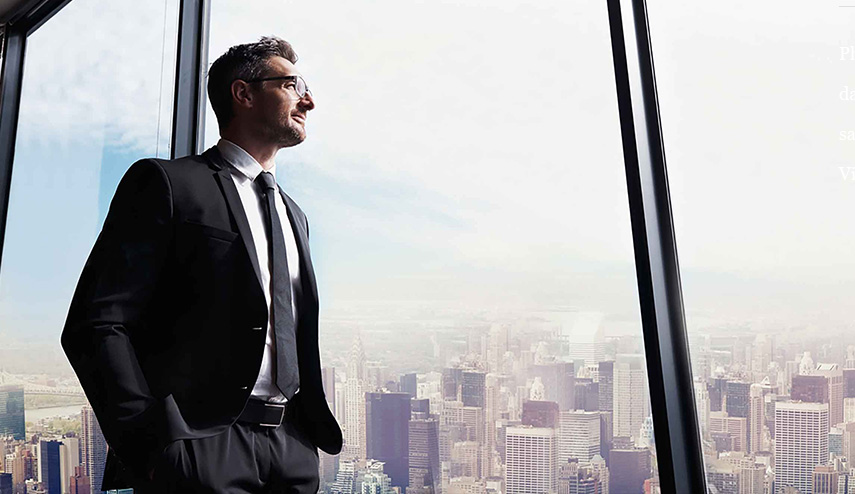 A picture of a man in a suit looking out a window